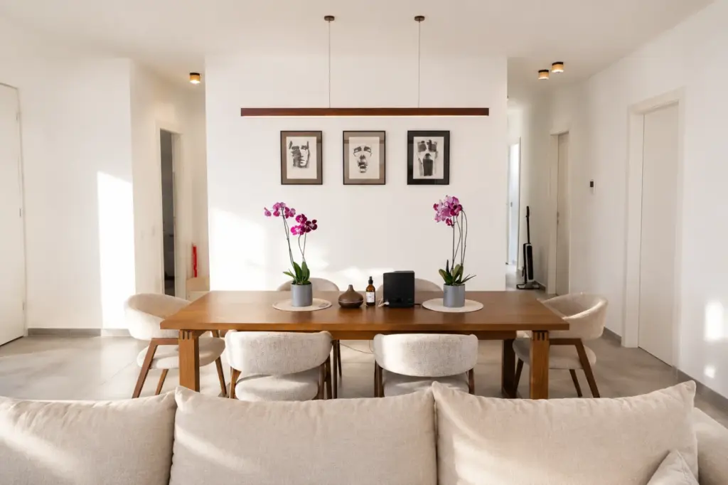 The waiting corner at OZ Clinic - a wooden table, armchairs and orchids